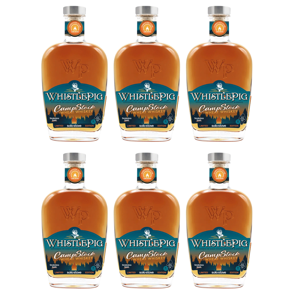 Product photo of six WhistlePig CampStock Wheat Whiskey bottles, each featuring amber liquid, a dark teal label with forest and campfire graphics, "Solo Stove Edition" text, and a silver cap with an orange Campfire Club logo, all on a white background